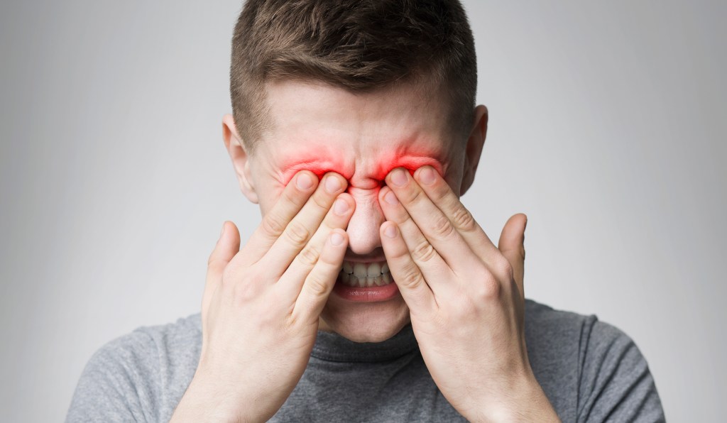 Man rubbing eyes